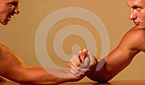 Strength and technique. Twins competitors arm wrestling. Men competitors try to win victory or revenge. Strength skills