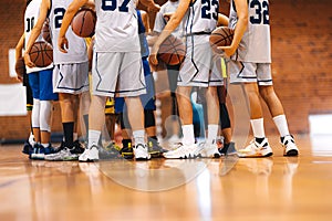 Strength in Unity: Basketball Team Huddling Together for Victory. Youth Players in Basketball Team Gathering During Break Time