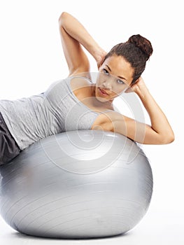 Strengthening her core muscles. A gorgeous young woman doing exercises with a pilates ball.