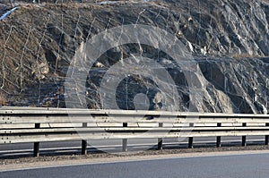 Strengthening the slope with a steel net anchored deep into the rock. falling rocks do not fall on the road. Double barriers are o