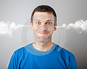 Stress and anger, angry upset man with head pressure and smoke coming out from his head