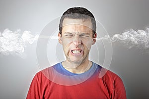 Stress and anger, angry upset man with head pressure and smoke coming out from his head