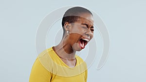 Stress, anxiety and angry black woman screaming in studio with broken heart, grief or fear on grey background