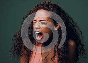 Stress, anxiety and angry woman scream in studio for fear, mistake or psychology crisis on green background. Depression