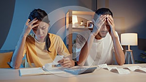 Stress asia couple man and woman use calculator for calculate family budget, debts, expenses during financial economic crisis at