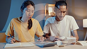 Stress asia couple man and woman use calculator for calculate family budget, debts, expenses during financial economic crisis at