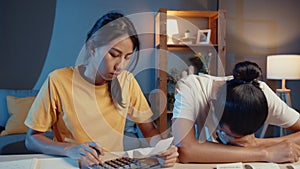 Stress asia couple man and woman use calculator for calculate family budget, debts, expenses during financial economic crisis at