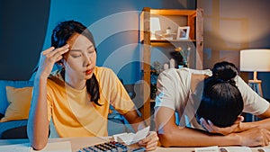 Stress asia couple man and woman use calculator for calculate family budget, debts, expenses during financial economic crisis at