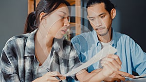 Stress asia couple man and woman use calculator for calculate family budget, debts, monthly expenses during financial economic