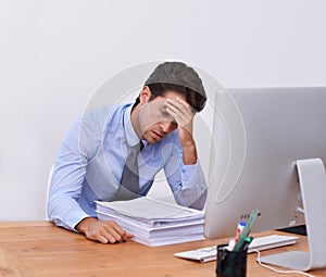 Stress, business man and headache with paperwork from corporate career at office desk. Anxiety, lawyer deadline and