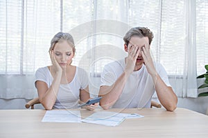 Stress caucasian Couple using calculator and calculate family budget, Debts, monthly expenses in home during Financial economic