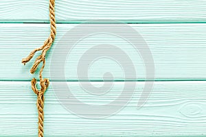 Stress concept with breaking rope on mint green wooden background top view mockup