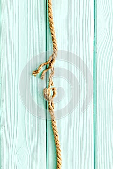 Stress concept with breaking rope on mint green wooden background top view mockup