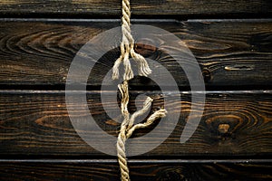 Stress concept with breaking rope on wooden background top view mockup