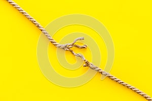 Stress concept with breaking rope on yellow background top view mockup
