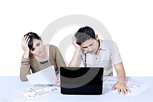 Stress couple paying bills online - isolated