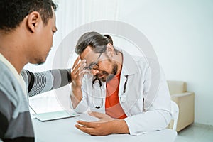 Stress doctor and patient try to comfort him