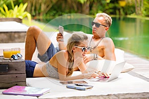 Couple relaxing in hot summer day and using tech