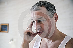 Stress, headache, desperation, grief and people concept. Frustrated young man massaging his nose and keeping eyes closed