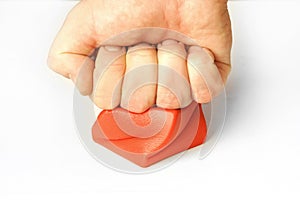 Stress management arm fist hitting pressing red cube