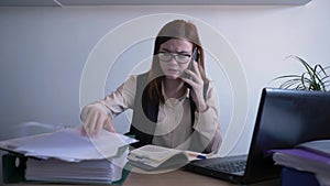 Stress management, businesswoman is nervous and screaming out of anger at an employee while talking on phone due to job