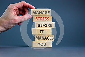 Stress management symbol. Wooden blocks with words manage stress before it manages you. Beautiful grey background. Doctor hand.