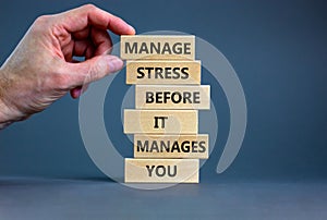 Stress management symbol. Wooden blocks with words manage stress before it manages you. Beautiful grey background. Doctor hand.