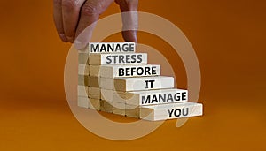 Stress management symbol. Wooden blocks with words manage stress before it manages you. Beautiful orange background. Doctor hand.