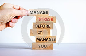 Stress management symbol. Wooden blocks with words manage stress before it manages you. Beautiful white background. Doctor hand.