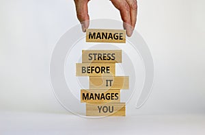 Stress management symbol. Wooden blocks with words manage stress before it manages you. Beautiful white background. Doctor hand.