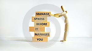 Stress management symbol. Wooden blocks with words manage stress before it manages you. Beautiful white background. Human model.