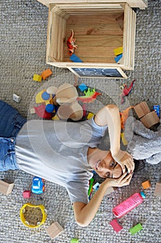 Stress, mother or toys in messy living room for spring cleaning, housekeeping or tidy maintenance in top view. Anxiety