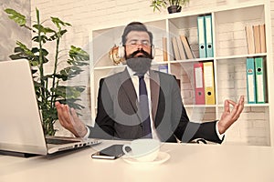 Stress relieving activity that work wonders. Engineer meditate at work. Bearded man listen to music with mudra gesture