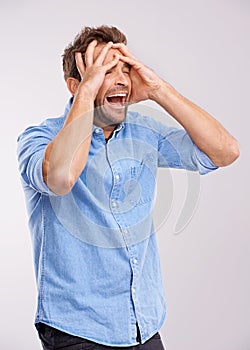Stress, screaming or man with hands on face in studio for mental health, crisis or mistake on white background. Anxiety