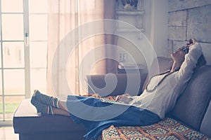 Stress and tired concept with caucasian woman at home with personal laptop computer on her legs - people lockdown for quarantine photo