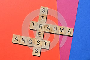 Stress, Trauma, Angst, crossword on red, pink and blue