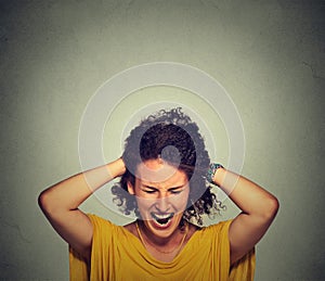 Stress. Woman stressed is going crazy pulling her hair in frustration photo