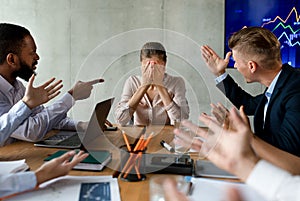 Stress At Workplace. Group Of Collagues Shouting At Female Employee In Office