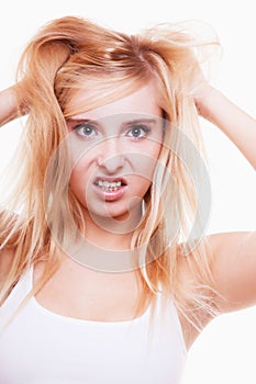 Stress. Young woman frustrated pulling her hair on