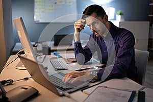 Stressed Accountant Working Late In Office