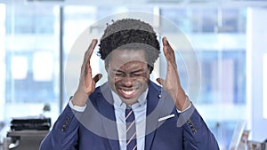 Stressed African American Businessman Screaming in Office