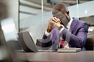 Stressed african american businessman in suit having burnout