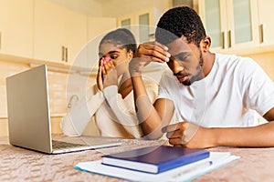 Stressed african american couple looking frustrated after getting a bad news from family