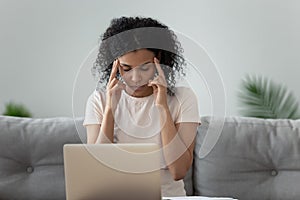 Unhealthy black woman having headache overwhelmed with computer work