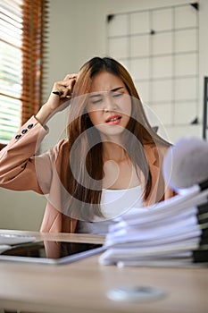 Stressed and angered Asian businesswoman dissatisfied with the report