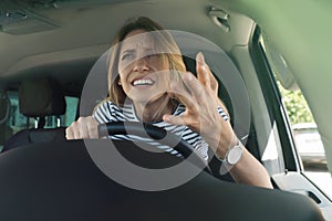 Stressed angry woman in driver`s seat of modern car, view through windshield