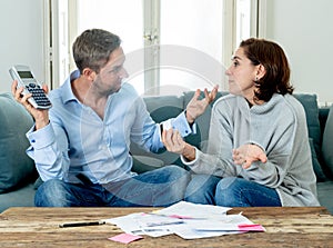 Stressed young couple having an argument over credit car debts payments and home finance