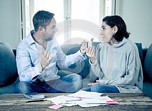 Stressed young couple having an argument over credit car debts payments and home finance