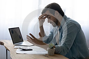 Stressed anxious young man having financial problems.