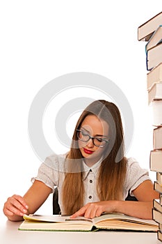 Stressed asian caucasian woman student learning in tons of books